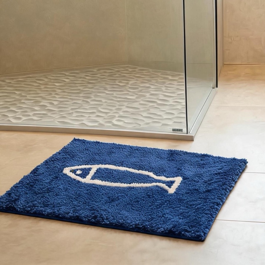 Original Etsy listing photo: a navy bath rug with a white fish outline on a tiled floor in front of a glass shower