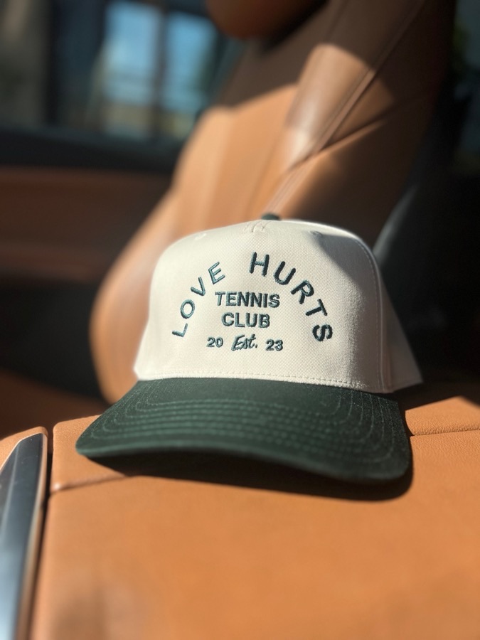 Original Etsy listing photo: a cream and green embroidered snapback cap on a car seat